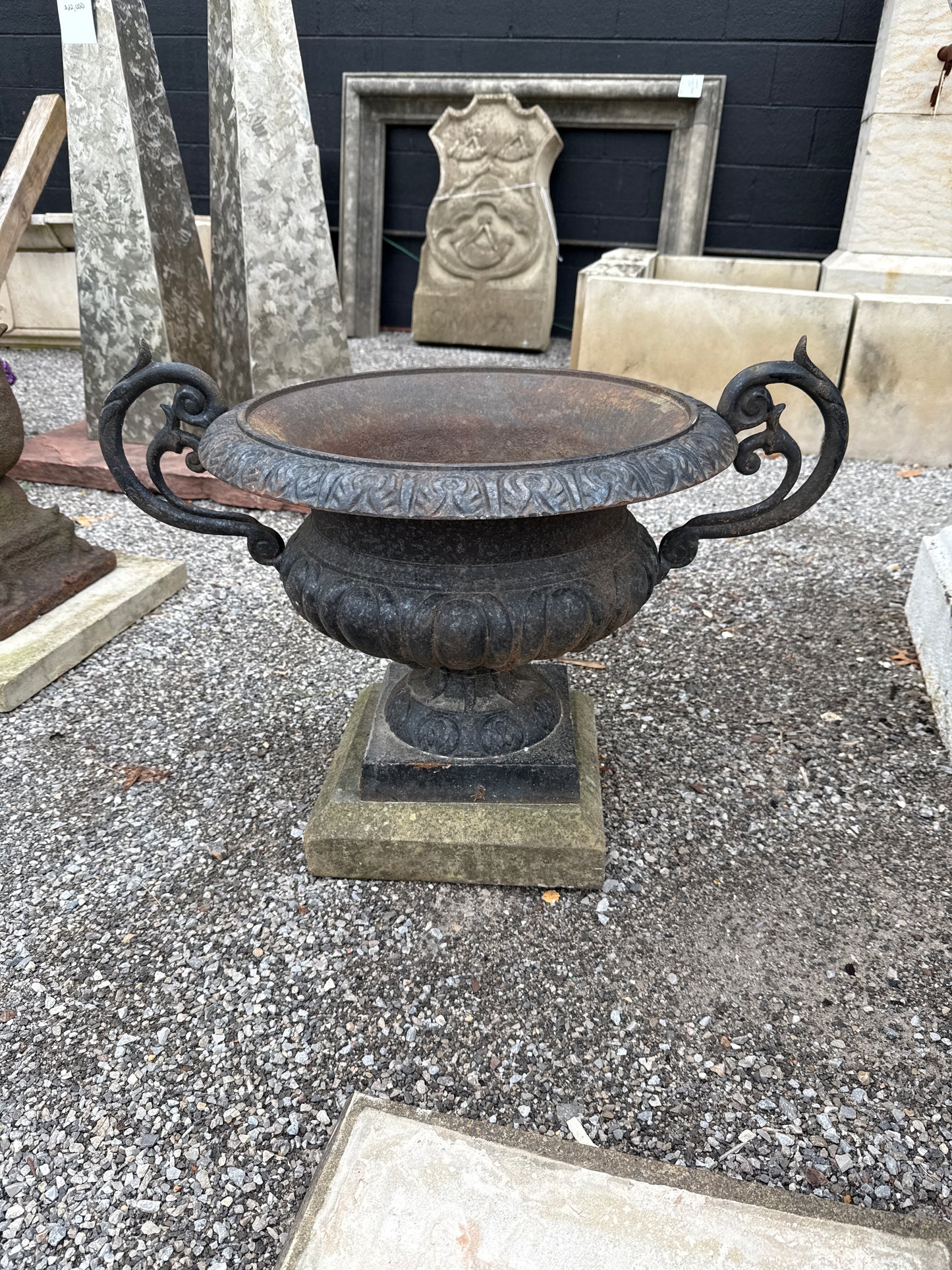 Pair of Cast Iron Urns on Stone Plinths