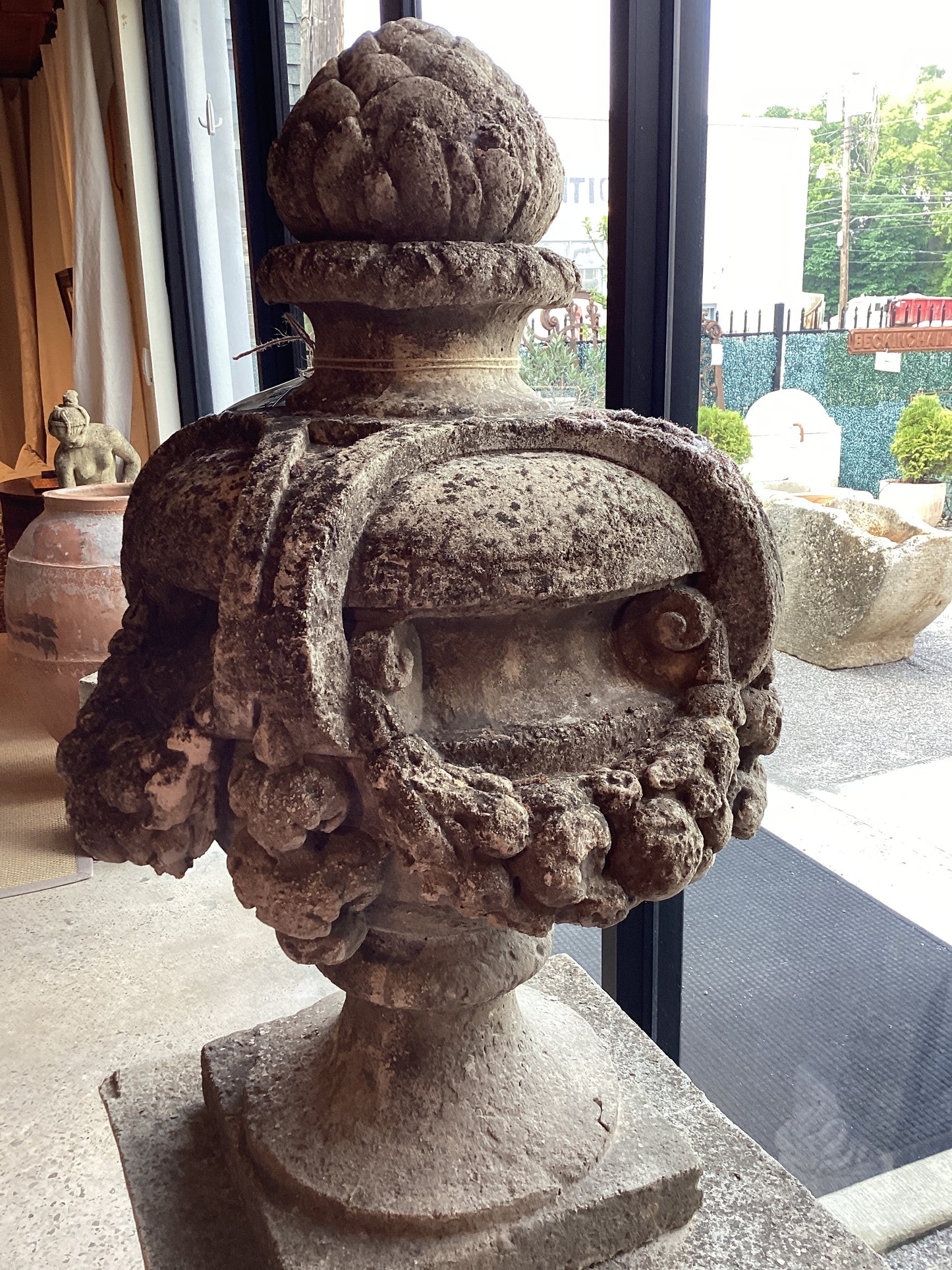 Stone Urn with finial atop a stone base